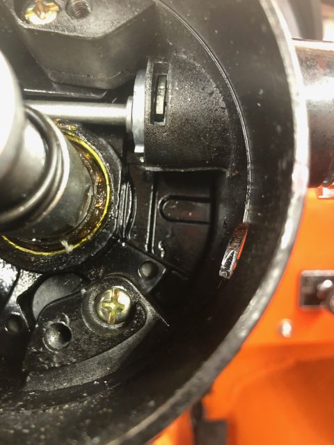 1992 Jeep Wrangler - A close-up view inside a black housing shows metallic components, including a silver shaft with a bearing and a small silver lever with a r…