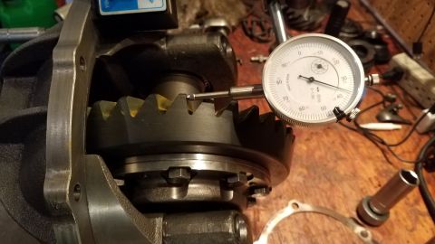1985 Ford Bronco - A close-up view shows a differential gear being measured with a dial indicator. The gear has yellow markings on its teeth, and the dial ind…