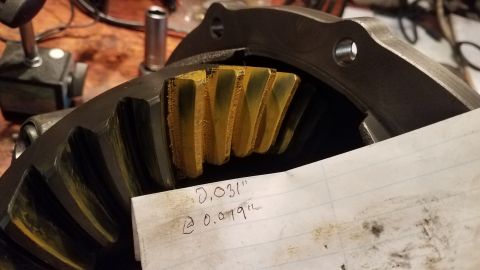 1985 Ford Bronco - This close-up photo shows the yellow marking compound on the teeth of a differential ring gear, indicating proper contact. A piece of paper…