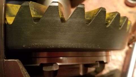 1985 Ford Bronco - Close-up view of a black ring gear with yellow markings on the teeth. Visible text on the gear reads "M3 F52011 2494 E".