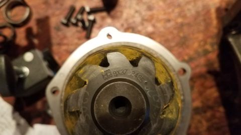 1985 Ford Bronco - A close-up view of a metal part with markings that read "M9X37 2495". The part appears to be a component of a vehicle, possibly a water pum…