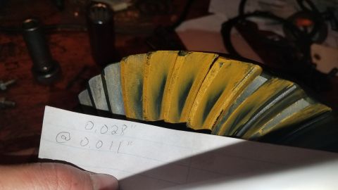 1985 Ford Bronco - A close-up shot shows a differential gear with yellow and blue markings on its teeth. A piece of paper in the foreground has handwritten me…