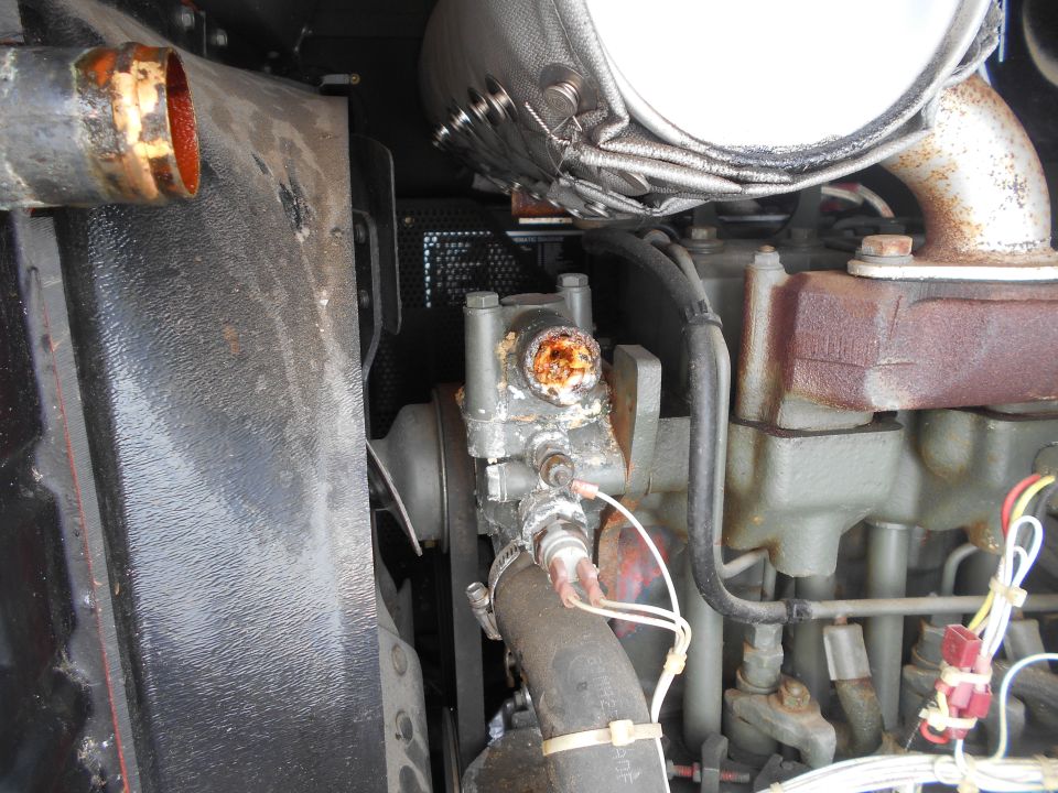 Corroded engine part with hoses and wiring
