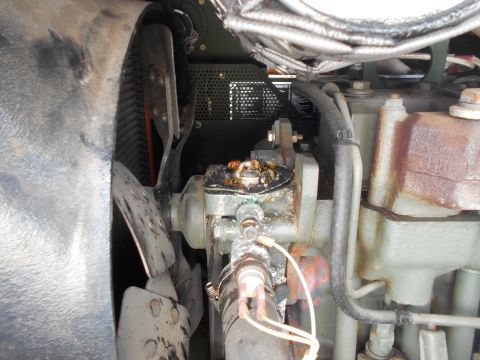 1992 Ford Bronco - A close-up view of the engine compartment of a vehicle, showing a fan, radiator, and various engine components with some signs of wear and…