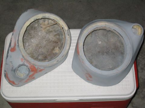 1989 Ford Bronco - A pair of custom fiberglass speaker pods sitting on a red-and-white cooler, bodyfilled and sanded with gray primer and orange filler showin…