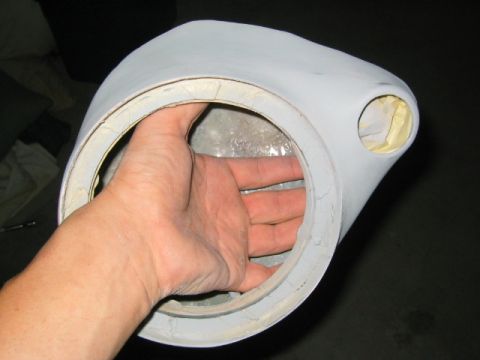 1989 Ford Bronco - A hand holds up a custom fiberglass speaker pod finished in gray primer, showing the large round woofer opening with its mounting ring and…