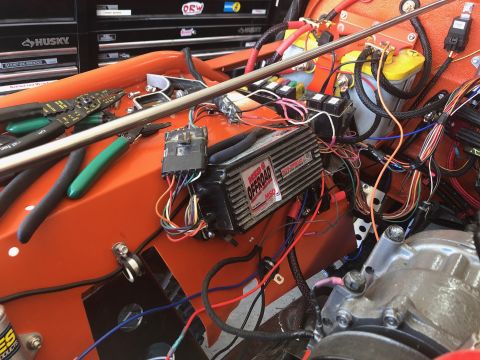 1992 Jeep Wrangler - Close-up view of a vehicle's engine bay, focusing on the wiring and an MSD ignition box. Tools like wire strippers and pliers are laid out…