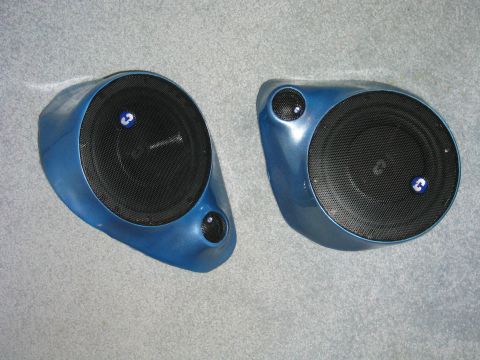 1989 Ford Bronco - Finished pair of custom fiberglass kick panel speaker pods sprayed metallic blue, each holding a black mesh-grilled woofer and a small twee…