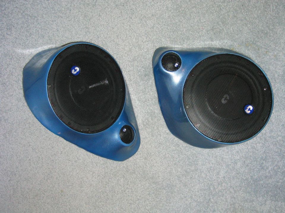 Finished metallic blue fiberglass speaker pods with woofers and tweeters