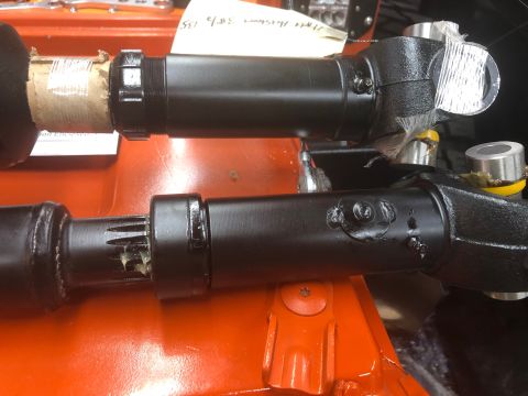 1992 Jeep Wrangler - Two black driveshafts are shown, one above the other, with visible splines and grease on the lower shaft. The upper shaft has a threaded ad…