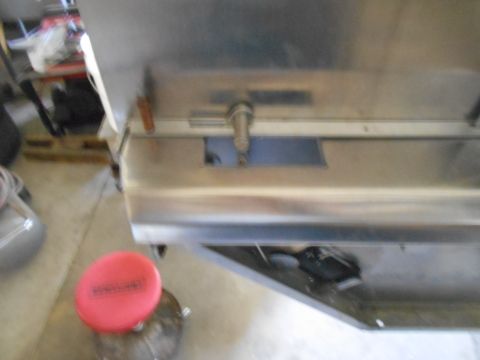 1992 Ford Bronco - A close-up, slightly blurry view of the stainless steel exterior of a vehicle, possibly a food truck or concession trailer, with a red lid…