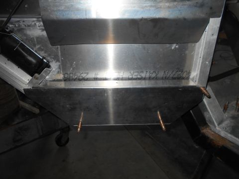 1992 Ford Bronco - A close-up view of the underside of a vehicle's metal bodywork, showing some stamped text and copper rivets. The text appears to read "4027…