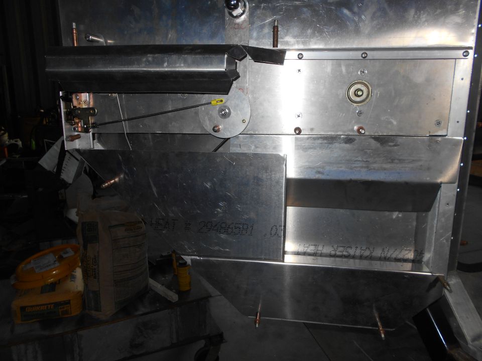 Close-up of metal fabrication with bags of concrete and a spool.