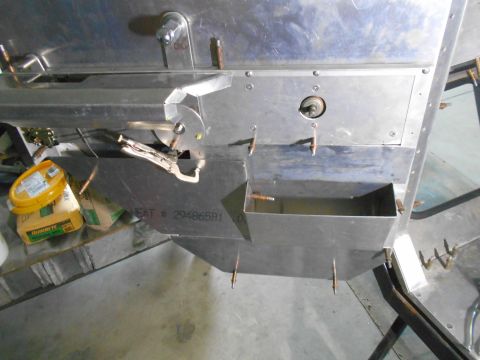 1992 Ford Bronco - A close-up view of a custom metal fabrication project, likely part of a vehicle build, showing various stainless steel components, fastener…