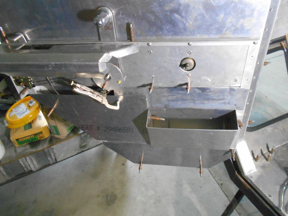 Close-up of custom metal fabrication with fasteners and a toolbox.
