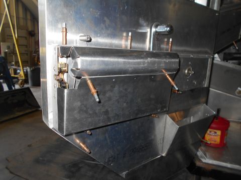1992 Ford Bronco - A close-up view of a stainless steel machine with copper piping and a red Folgers coffee container in the background.