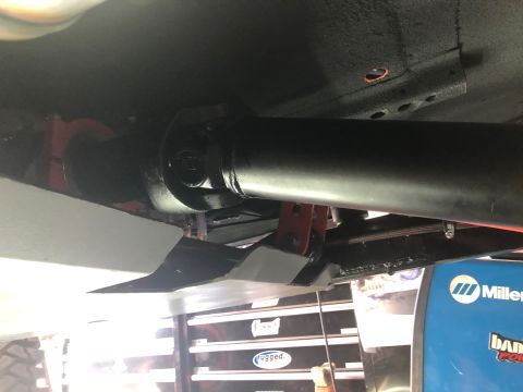 1992 Jeep Wrangler - Underside view shows a driveshaft and skid plate, with a welding machine visible in the background.
