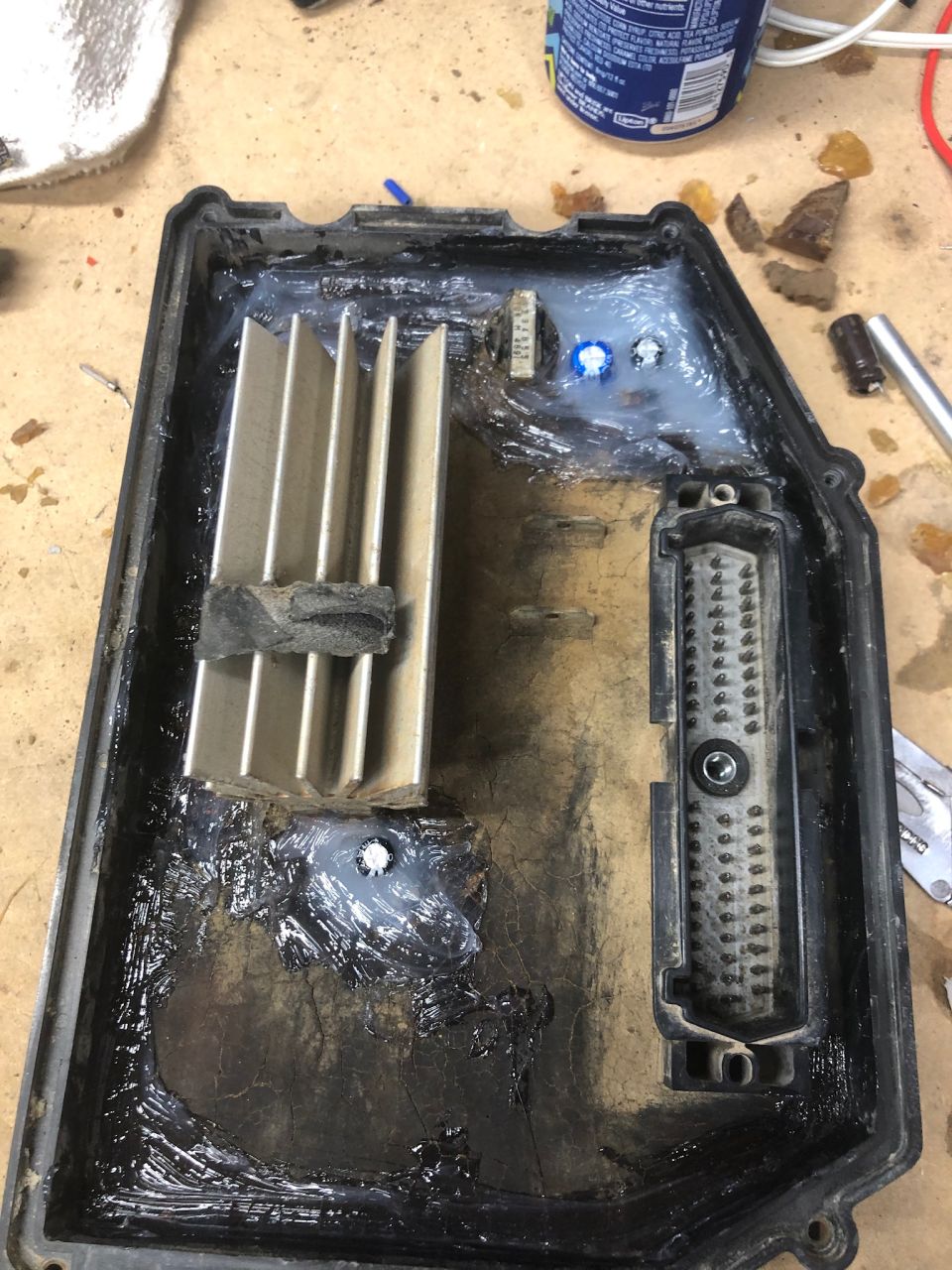 Inside of a black electronic enclosure with heatsink and connector