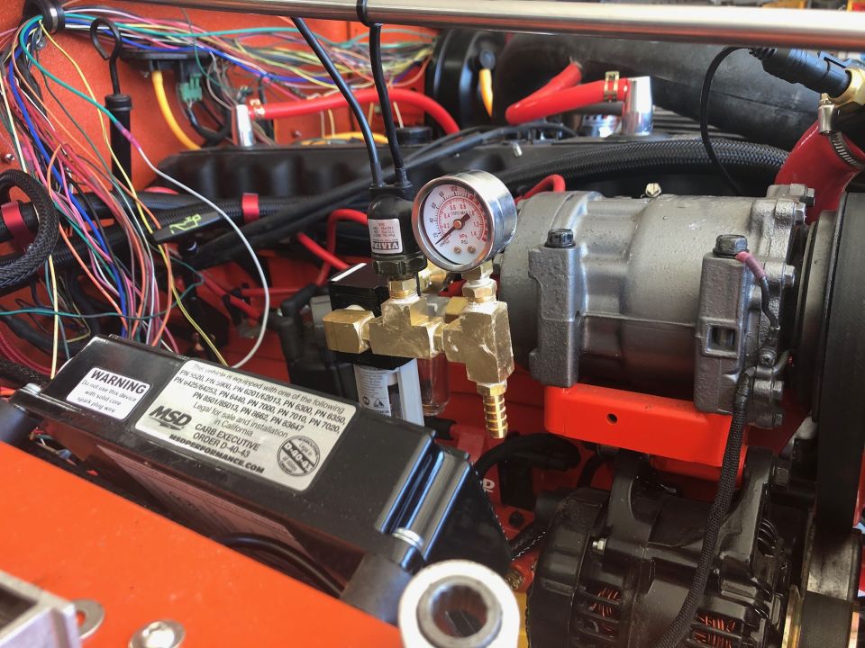 Engine bay of a 1992 Jeep Wrangler with AC compressor, wiring, and MSD box.