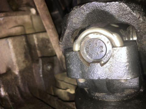 1980 Ford Bronco - A close-up view of a U-joint on a vehicle's driveshaft. Visible text on the U-joint cap reads "SPICER 1350".