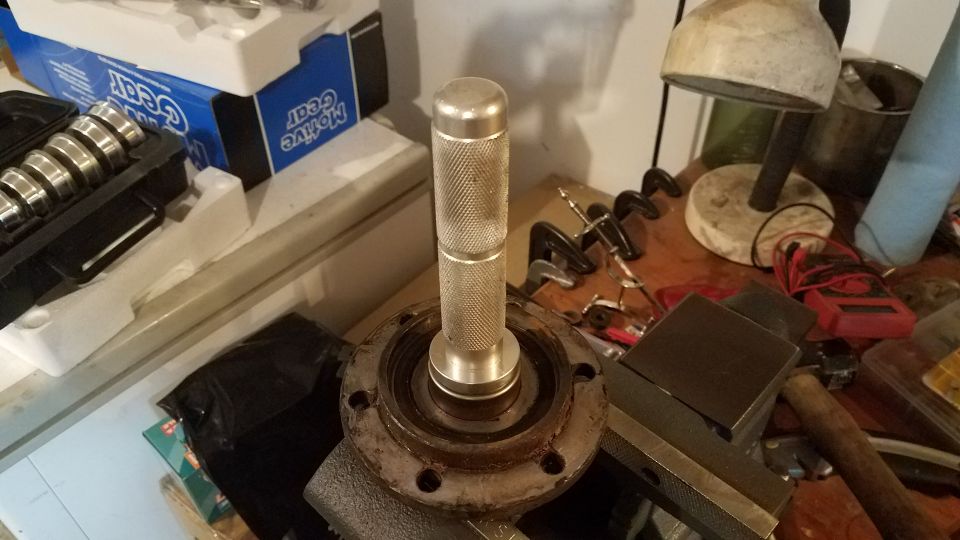 Bearing race installer tool on a rusty flange with 'Motive Gear' box in background