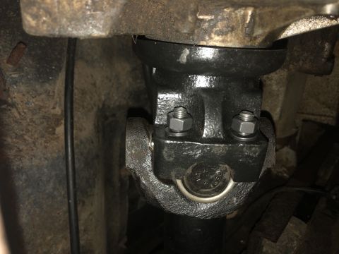 1980 Ford Bronco - Close-up view of a vehicle's driveshaft U-joint, showing mechanical components and fasteners.