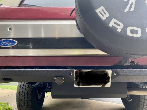 1994 Ford Bronco - Close-up of the rear of a Ford Bronco, showing the spare tire cover and bumper details.