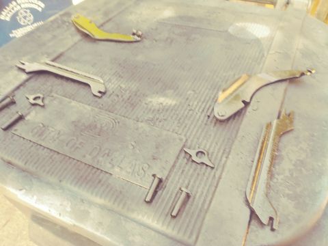 1996 Ford Bronco - Various metal brake parts are laid out on a surface with "CITY OF DALLAS" stamped into it.