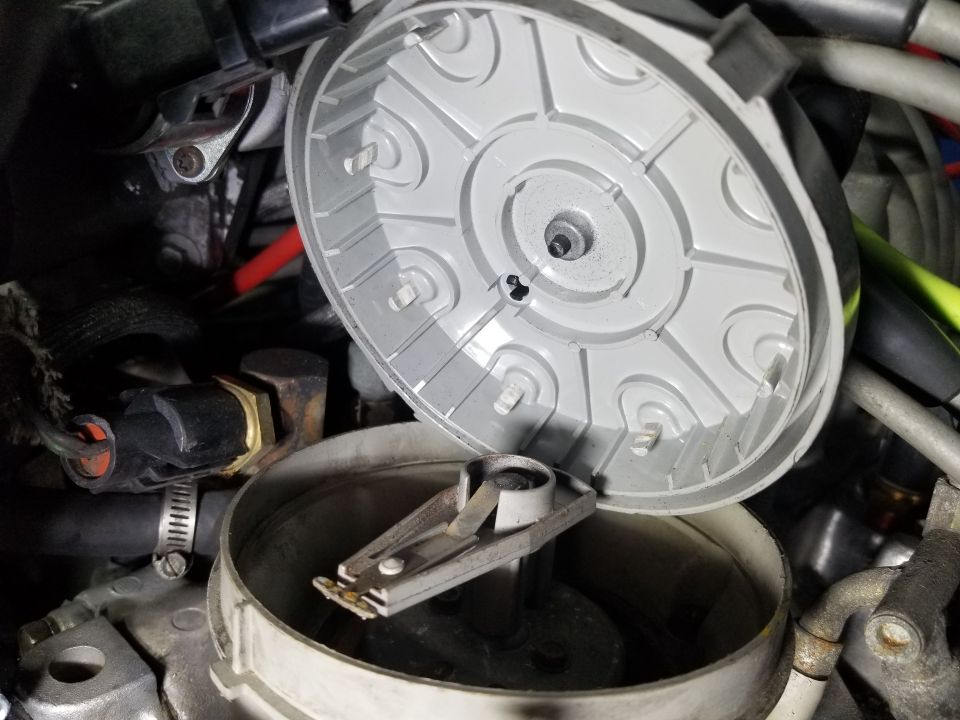 Distributor cap removed, showing rotor and spark plug wire terminals