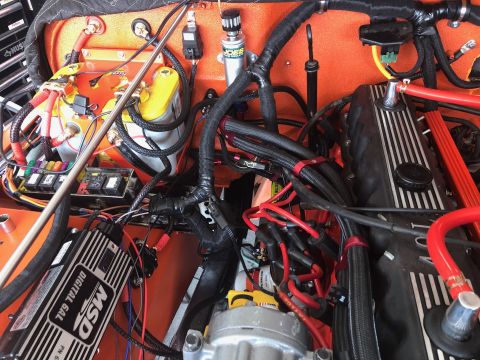 1992 Jeep Wrangler - Close-up view of a complex engine bay, showing numerous wires, fuses, and electronic components.