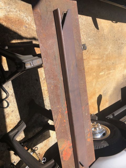 1992 Jeep Wrangler - Several pieces of rusty metal, possibly armor plating, lie on a concrete surface.