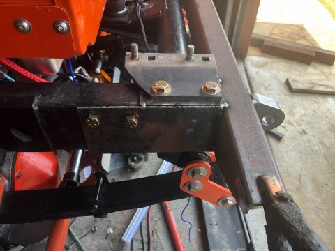 1992 Jeep Wrangler - Custom suspension part bolted to vehicle frame, with leaf spring visible.