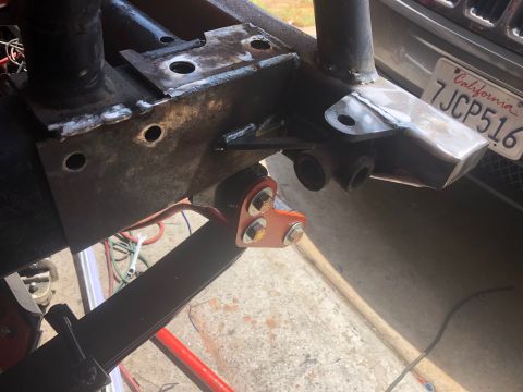 1992 Jeep Wrangler - Custom suspension bracket installed on Jeep frame, with a California license plate visible in the background.