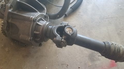 1985 Ford Bronco - Differential and driveshaft assembly shown on a concrete surface.