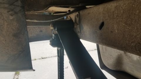 1985 Ford Bronco - Close-up of the undercarriage, focusing on the shock absorber and frame components.