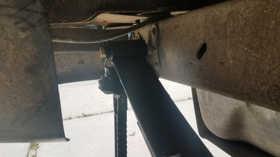 Undercarriage view of a shock absorber mounted to a frame