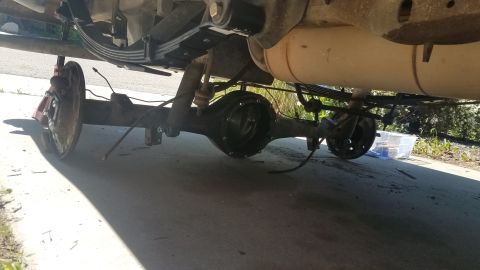 1985 Ford Bronco - Rear axle and suspension components are visible in this underside shot of a vehicle.
