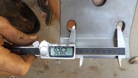 1985 Ford Bronco - A digital caliper measures a metal component, indicating a dimension of 9.262 inches.