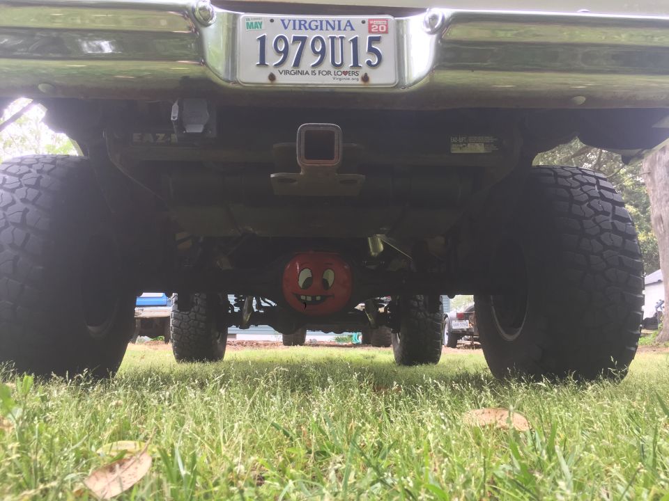 1979 Ford Bronco rear axle with a smiley face differential cover, large off-road tires, and a Virginia license plate