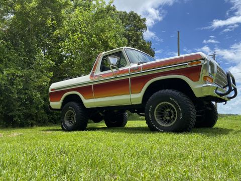 1979 Ford Bronco - This lifted 1979 Ford Bronco features a distinctive orange and white stripe pattern and BFGoodrich Mud-Terrain tires.