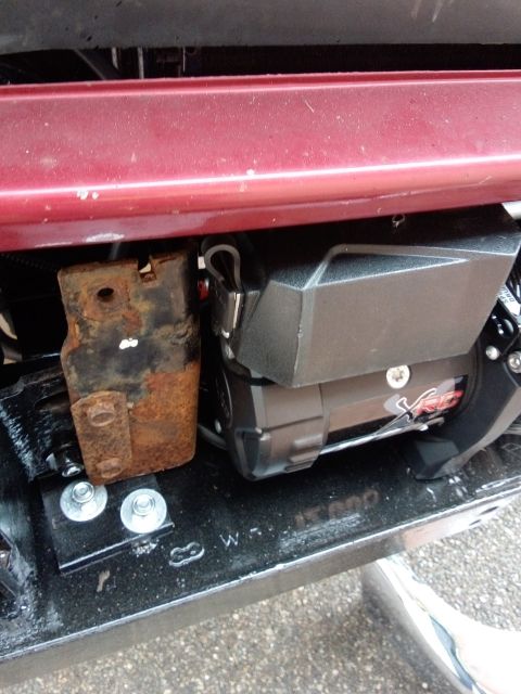 1994 Ford Bronco - Close-up of a winch and its mounting hardware, showing some rust on the bracket.