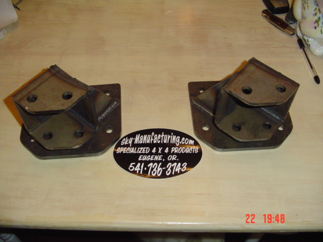 Two welded steel 4x4 bracket mounts on a table with a Sky-Manufacturing.com Eugene OR sticker