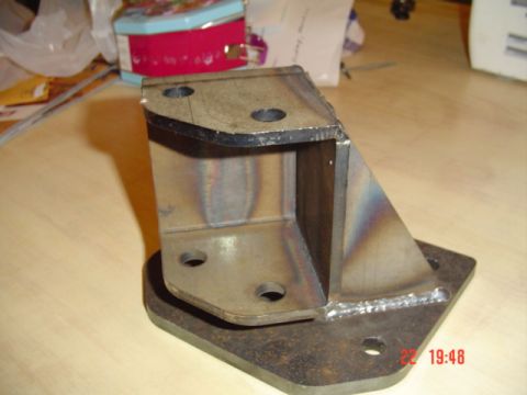 1989 Ford Bronco - Custom metal bracket with visible welds and bolt holes, likely a vehicle suspension part.