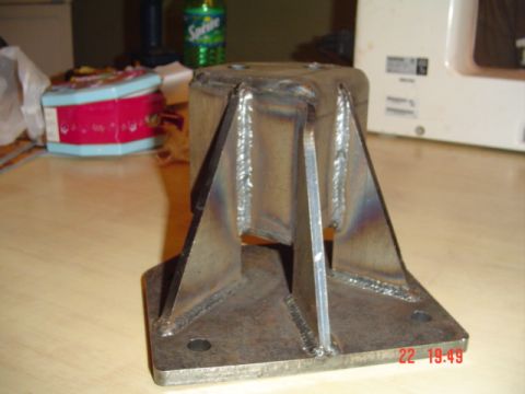 1989 Ford Bronco - A custom metal bracket with visible welds sits on a table next to a can of Sprite.