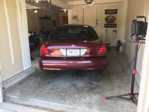 2004 Ford Crown Victoria - Rear view of a red 2004 Ford Crown Victoria parked in a garage.