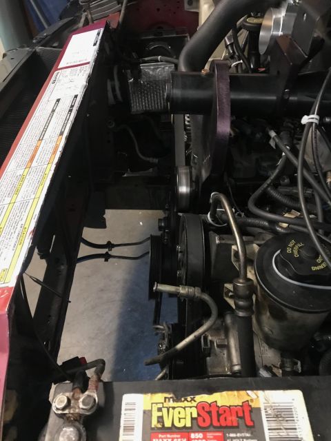 2000 Ford Explorer - Engine bay with supercharger components, belts, and hoses. Battery visible at bottom.