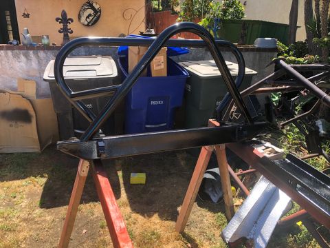 1992 Jeep Wrangler - A black roll cage and bumper assembly is shown outdoors, supported by sawhorses.