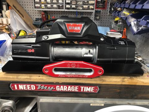 1992 Jeep Wrangler - Warn winch and red shackle mount on a workbench, with a garage-themed sign.