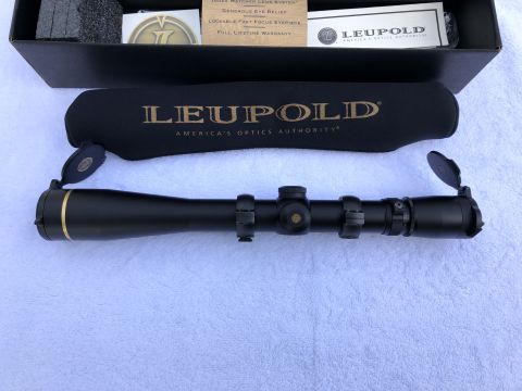 1995 Mercury Grand Marquis - A Leupold rifle scope is shown with its protective cover and original packaging.