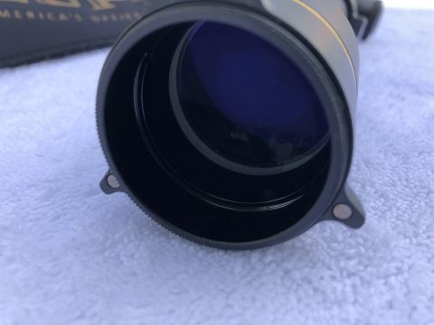 1995 Mercury Grand Marquis - A close-up view of a scope's lens, showing its blue coating and textured outer ring.